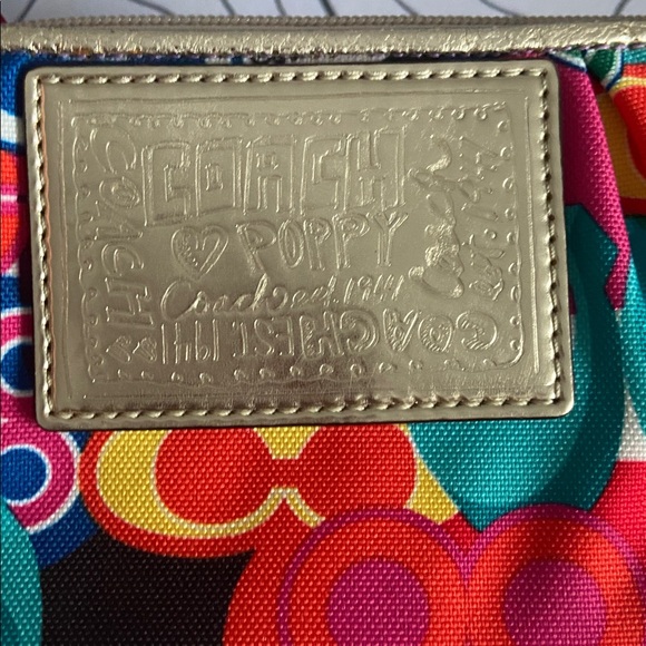 Coach Poppy wristlet with a multicolor graffiti-style